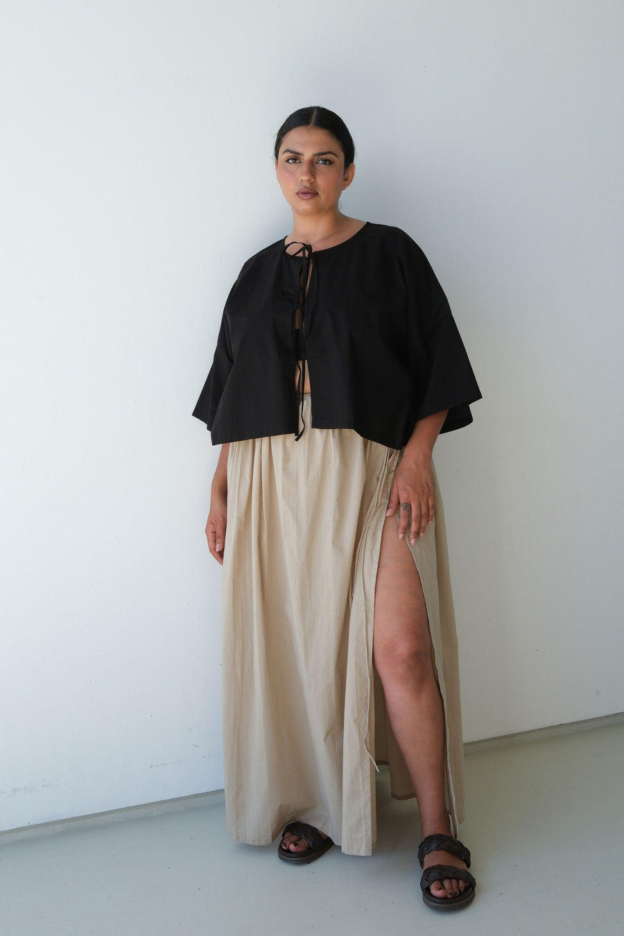 Mays wearing the Maya skirt in Ice Coffee with a black tie-front top